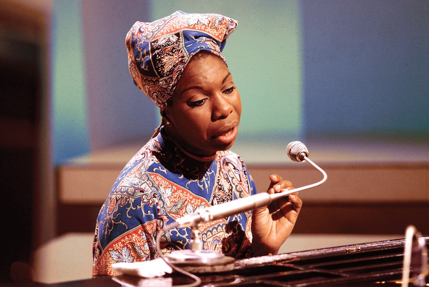 A picture of Nina Simone sitting at the piano